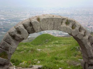 An arch way and a view of the town below.